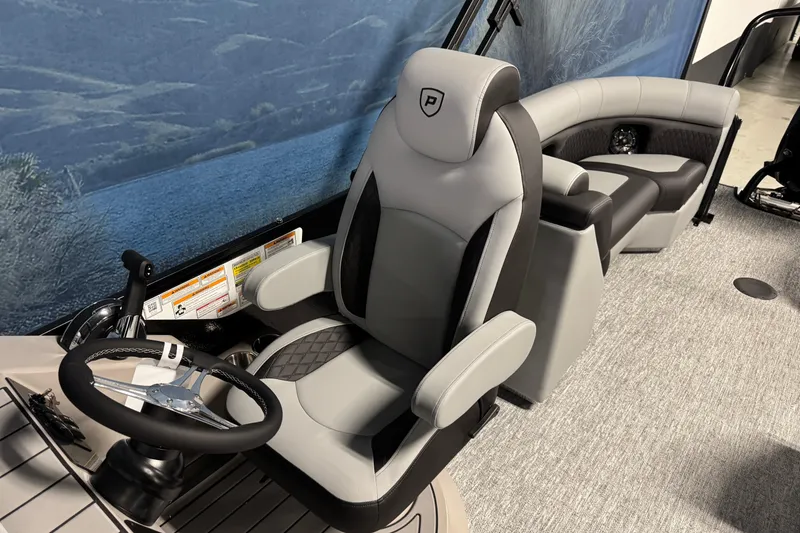 Slide: The Image of 2026 Premier 230 SunSation RF boat interior with luxurious seating and steering wheel. - 12
