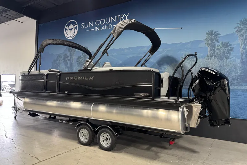Slide: The Image of 2026 Premier 230 SunSation RF pontoon boat displayed indoors on a trailer. - 5