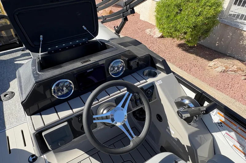 Slide: The Image of Steering console of 2026 Premier 230 Sunsation RL boat with modern controls and gauges. - 4