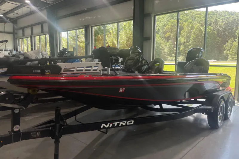 Slide: The Image of 2020 Nitro Z18 boat in showroom, black and red design, on trailer. - 3