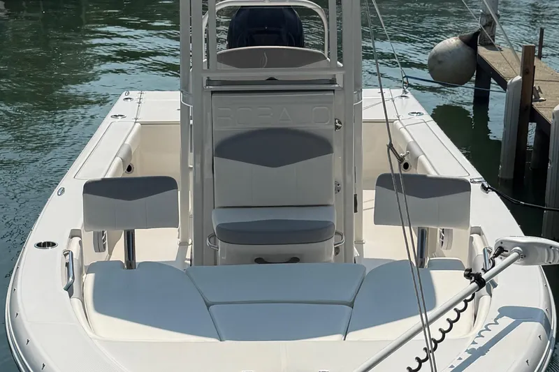 Slide: The Image of 2022 Robalo 226 Cayman boat docked, featuring spacious seating and sleek design. - 2