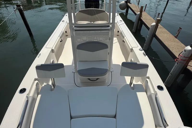 Slide: The Image of 2022 Robalo 226 Cayman boat interior with seating, docked at marina. - 23