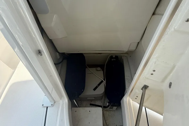 Slide: The Image of 2022 Robalo 226 Cayman boat storage compartment interior view. - 24
