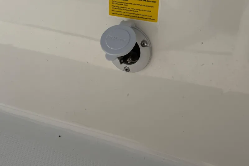 Slide: The Image of 2022 Robalo 226 Cayman boat power outlet on white surface. - 26