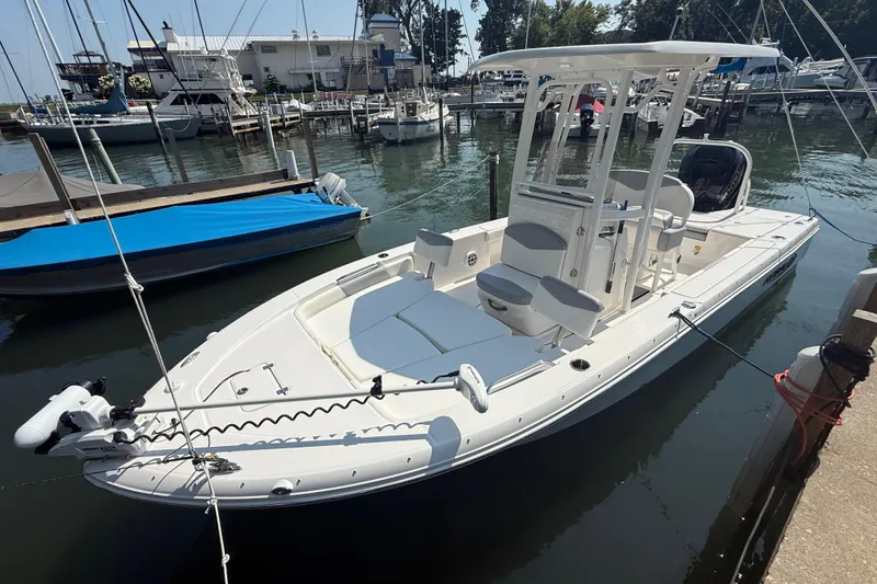 Slide: The Image of 2022 Robalo 226 Cayman boat docked at a marina, featuring a sleek white design. - 3