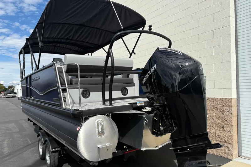 Slide: The Image of 2026 Premier 230 Sunsation RL pontoon boat with Mercury outboard motor, parked outdoors. - 5