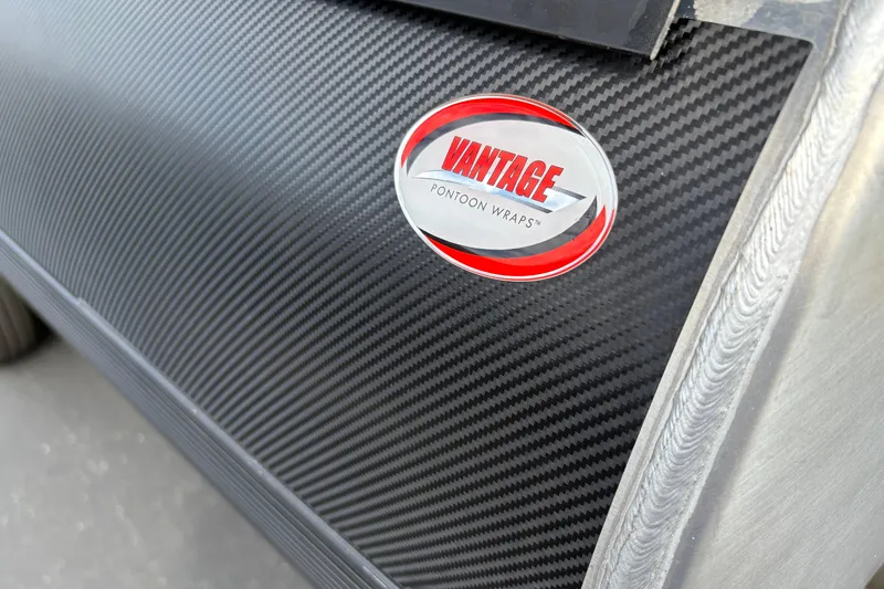 Slide: The Image of Carbon fiber wrap on 2026 Premier 230 Sunsation RL with Vantage Pontoon Wraps logo. - 6