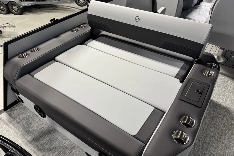 Slide: The Image of 2026 Premier 210 Sunsation RL boat interior with cushioned seating and cup holders. - 13