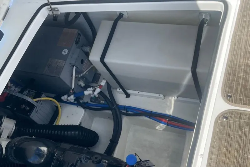 Slide: The Image of 2020 Four Winns V255 engine compartment with wiring and components visible. - 10