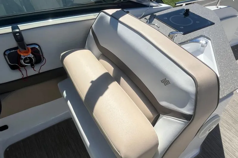 Slide: The Image of 2020 Four Winns V255 boat interior with beige seating and control panel. - 18