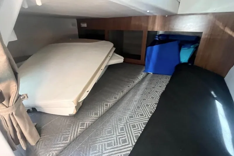 Slide: The Image of 2020 Four Winns V255 cabin interior with cushions and storage space. - 27