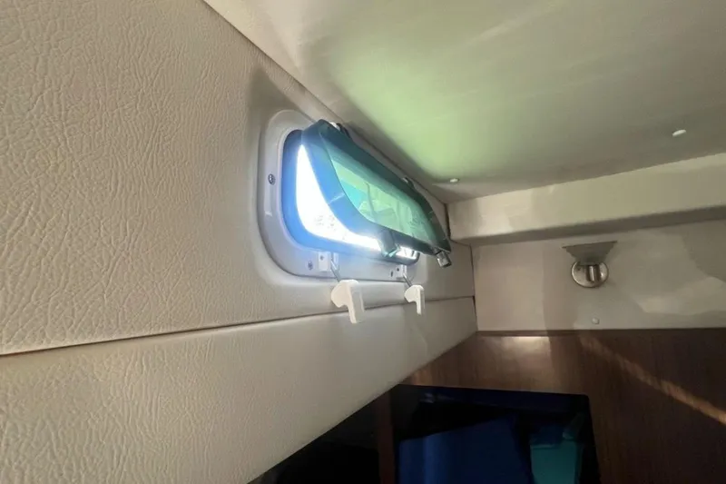 Slide: The Image of Interior view of 2020 Four Winns V255 boat cabin window. - 28