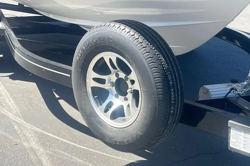 Slide: The Image of Trailer tire of a 2020 Four Winns V255 boat on a sunny day. - 3