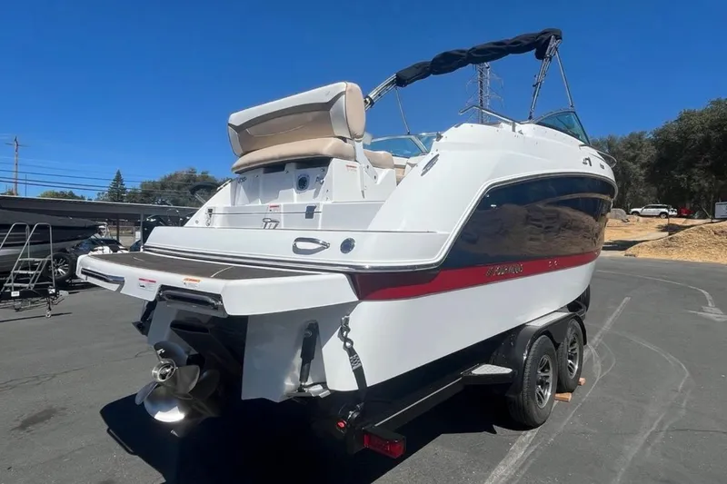 Slide: The Image of 2020 Four Winns V255 boat on trailer, rear view, sunny day. - 35