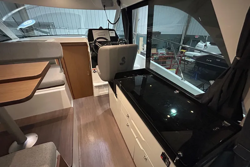 Slide: The Image of 2020 Beneteau Antares 9 boat interior with seating and table, showcasing modern design. - 10