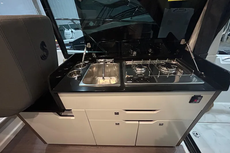 Slide: The Image of Interior of 2020 Beneteau Antares boat with seating and table. - 11