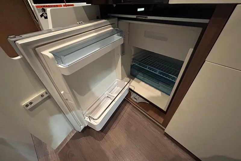 Slide: The Image of Interior of 2020 Beneteau Antares boat with modern seating and navigation equipment. - 13