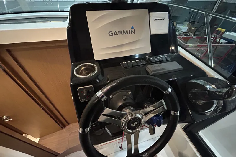 Slide: The Image of Interior of 2020 Beneteau Antares boat with helm, seating, and table. - 14