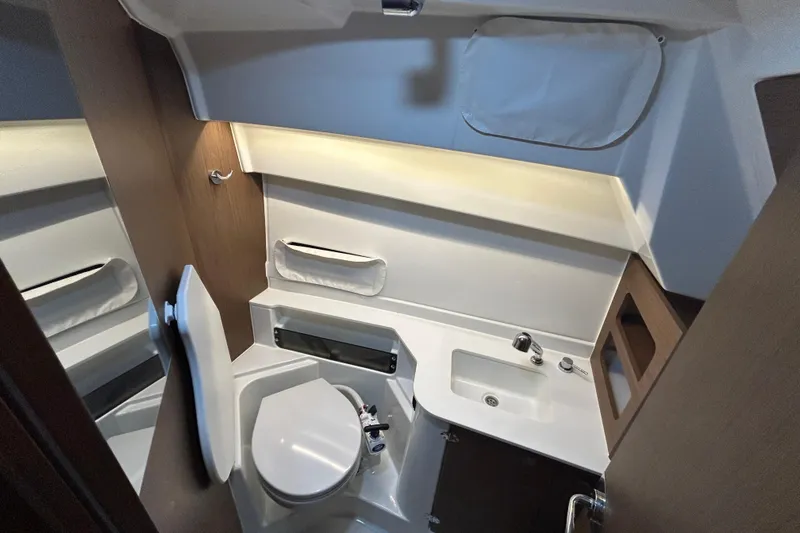 Slide: The Image of 2020 Beneteau Antares cabin interior with gray cushions and wooden accents. - 5