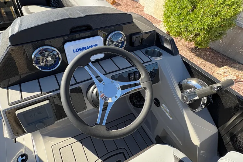 Slide: The Image of 2026 Premier 210 Sunsation RL boat dashboard with steering wheel and controls. - 10