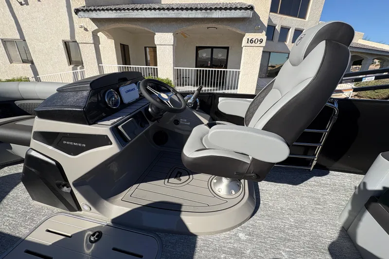 Slide: The Image of 2026 Premier 210 Sunsation RL boat helm with modern steering and comfortable seating. - 13