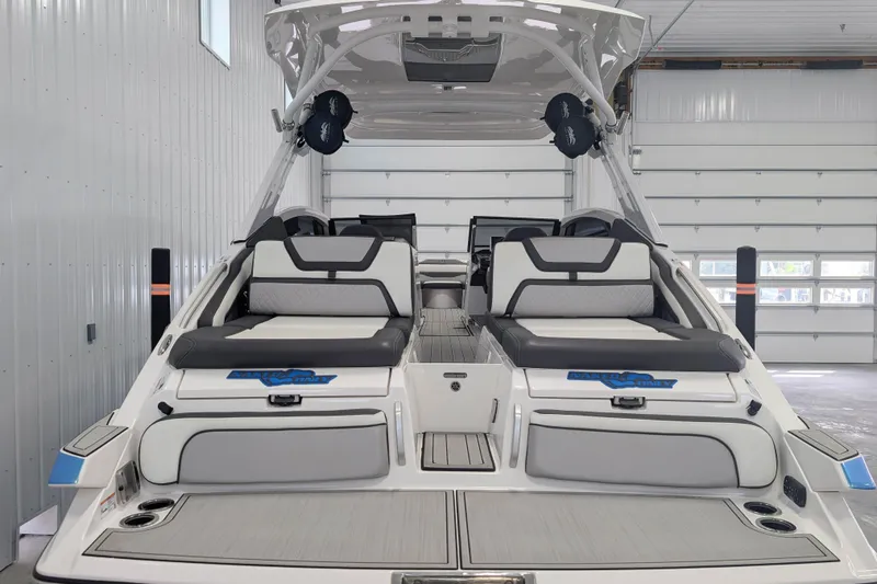 Slide: The Image of 2022 Yamaha Boats 275SD interior, featuring sleek seating and modern design in a spacious garage. - 3