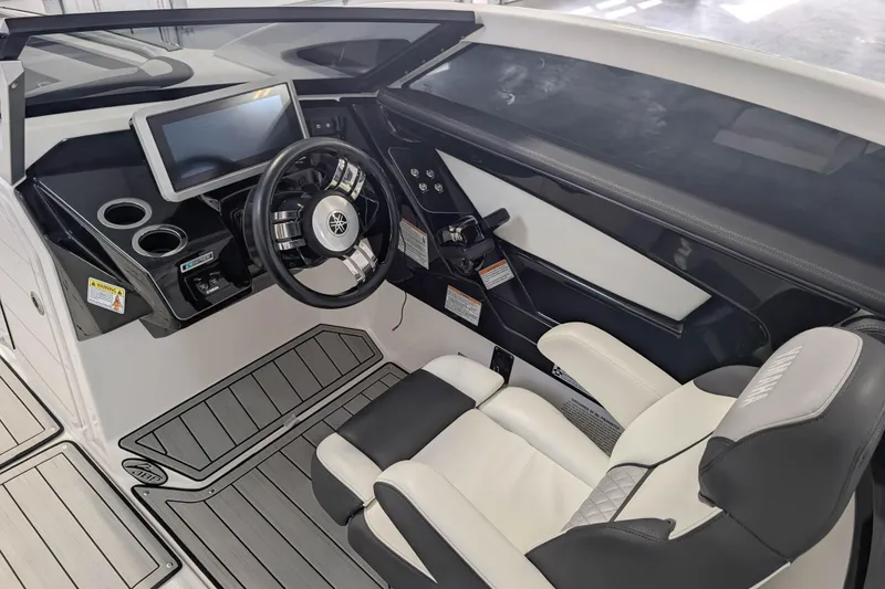 Slide: The Image of 2022 Yamaha Boats 275SD cockpit with modern steering, touchscreen, and luxury seating. - 5