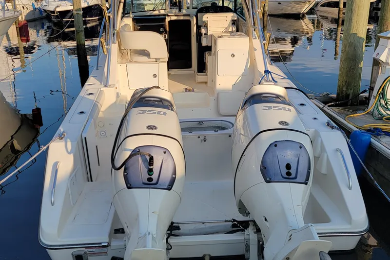 Slide: The Image of 2007 Pursuit OS 335 Offshore boat with twin 350 engines docked at marina. - 3