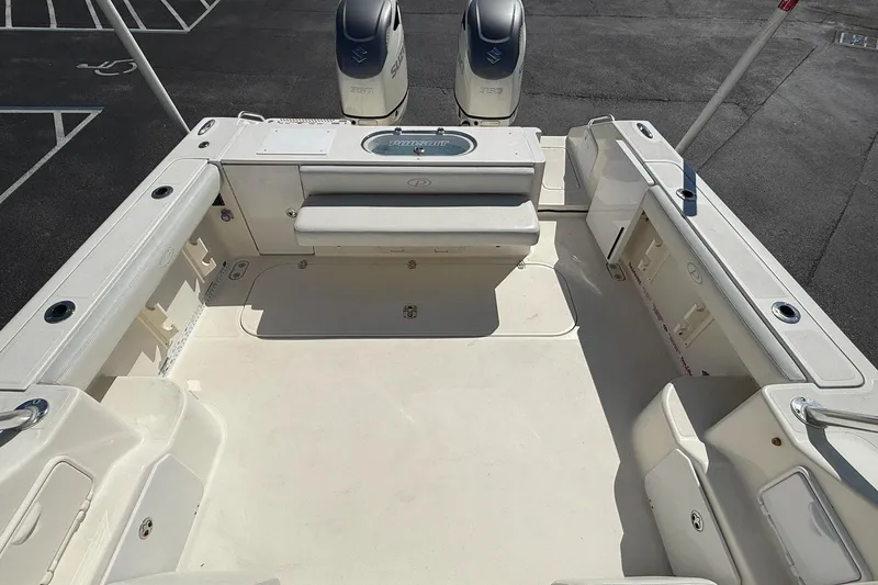 Slide: The Image of 2007 Pursuit OS 335 Offshore boat deck with twin engines, spacious seating, and storage compartments. - 4