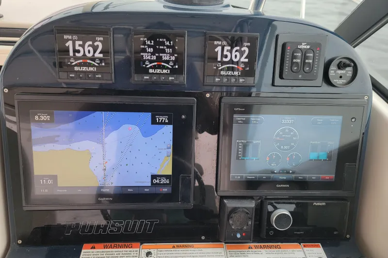 Slide: The Image of Dashboard of a 2007 Pursuit OS 335 Offshore boat with navigation and engine displays. - 6