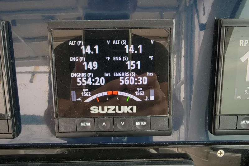 Slide: The Image of Suzuki engine display on 2007 Pursuit OS 335 Offshore boat, showing voltage and engine hours. - 7