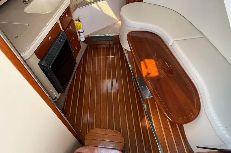 Slide: The Image of 2007 Pursuit OS 335 Offshore cabin interior with wood flooring and seating area. - 9