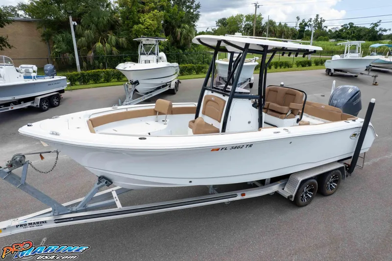 Slide: The Image of 2023 Sea Hunt Ultra 234 boat on trailer, parked outdoors. - 11