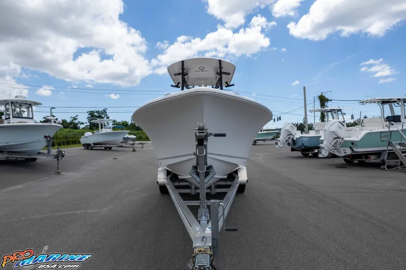Slide: The Image of 2023 Sea Hunt Ultra 234 boat on trailer under blue sky. - 13
