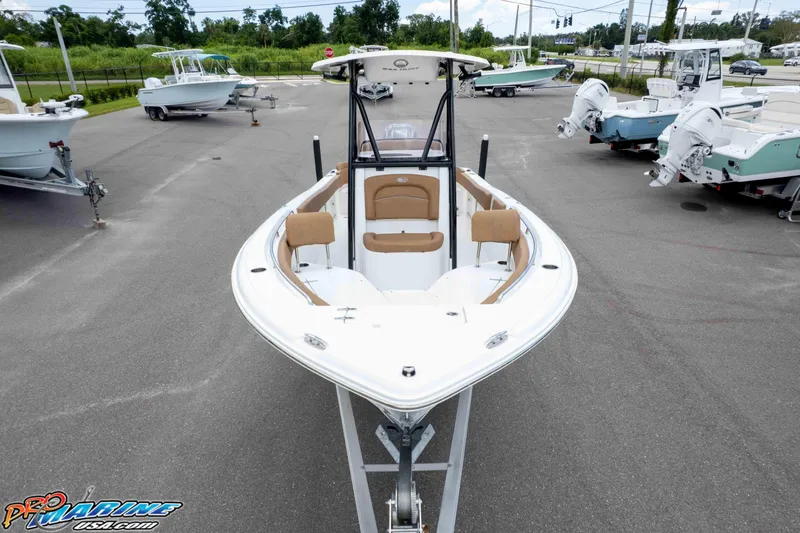 Slide: The Image of 2023 Sea Hunt Ultra 234 boat displayed in a dealership lot. - 14