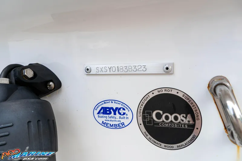 Slide: The Image of 2023 Sea Hunt Ultra 234 boat with ABYC and Coosa Composites labels. - 18