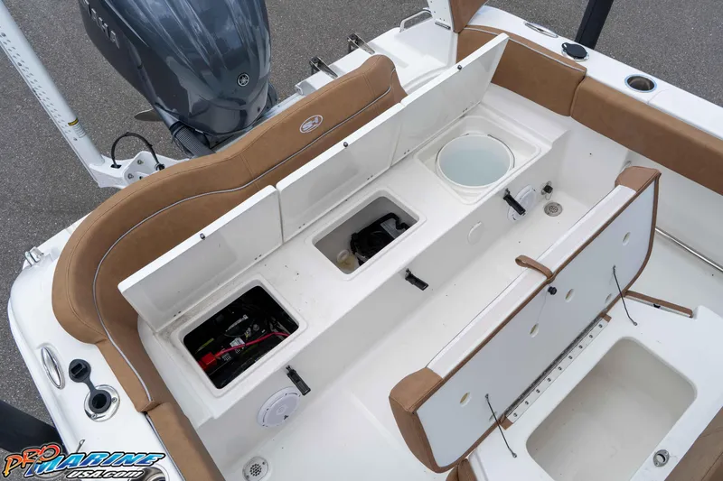 Slide: The Image of 2023 Sea Hunt Ultra 234 boat interior with storage compartments and seating. - 20