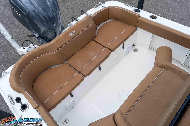 Slide: The Image of 2023 Sea Hunt Ultra 234 boat interior with brown cushioned seating and Yamaha engine. - 21