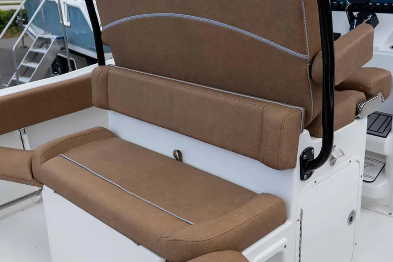 Slide: The Image of 2023 Sea Hunt Ultra 234 boat seating with brown upholstery and white base. - 22
