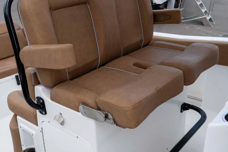 Slide: The Image of 2023 Sea Hunt Ultra 234 boat seat with brown upholstery and armrests. - 25