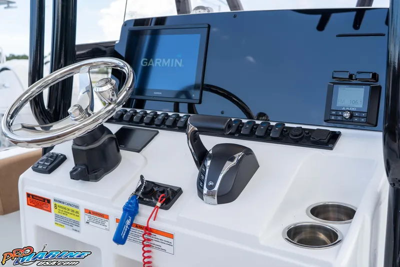 Slide: The Image of 2023 Sea Hunt Ultra 234 boat dashboard with Garmin display and JL Audio system. - 26