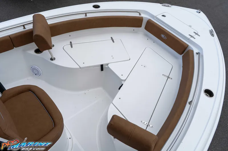 Slide: The Image of 2023 Sea Hunt Ultra 234 boat interior with brown seating and white deck. - 28