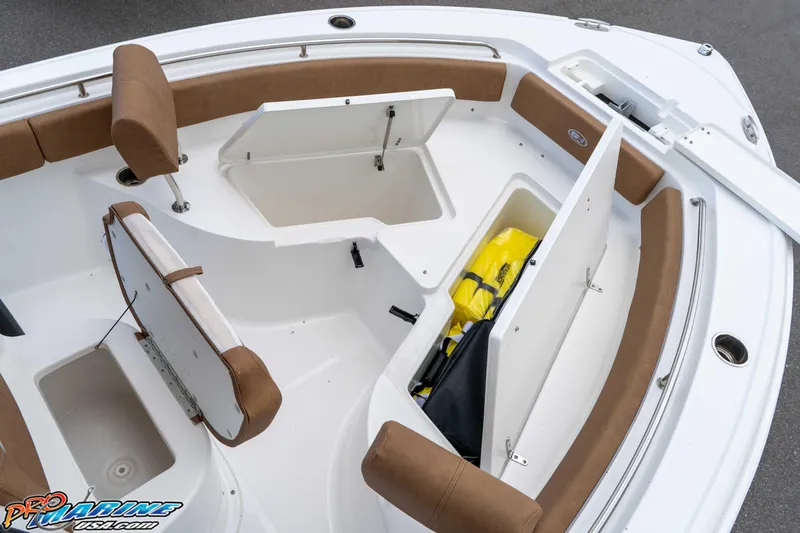 Slide: The Image of 2023 Sea Hunt Ultra 234 boat interior with open storage compartments and seating. - 29