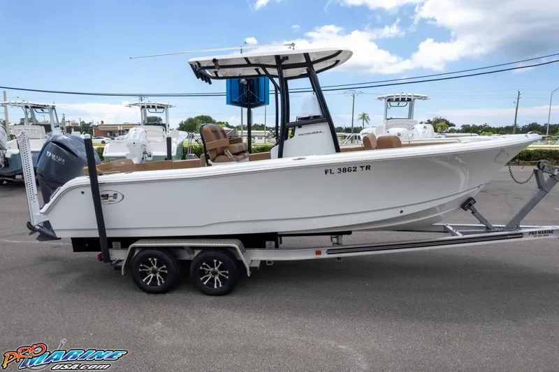 Slide: The Image of 2023 Sea Hunt Ultra 234 boat on trailer, side view, outdoors, clear sky. - 3
