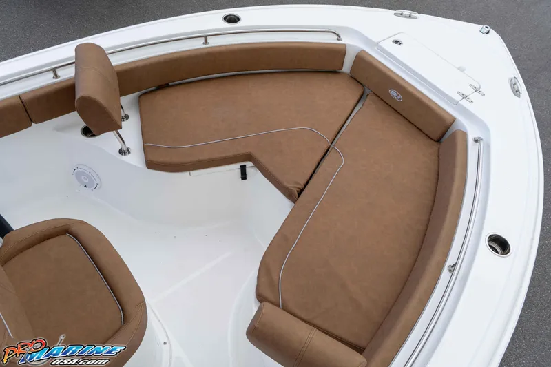 Slide: The Image of 2023 Sea Hunt Ultra 234 boat with brown cushioned seating and white deck. - 30