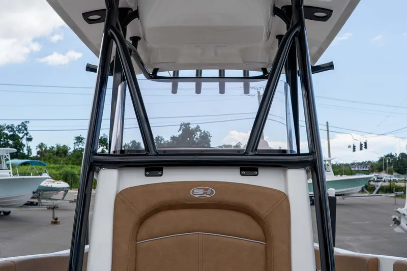 Slide: The Image of 2023 Sea Hunt Ultra 234 boat interior with brown seating and black frame. - 32