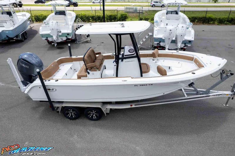 Slide: The Image of 2023 Sea Hunt Ultra 234 boat on trailer, featuring Yamaha engine, parked in marina. - 4