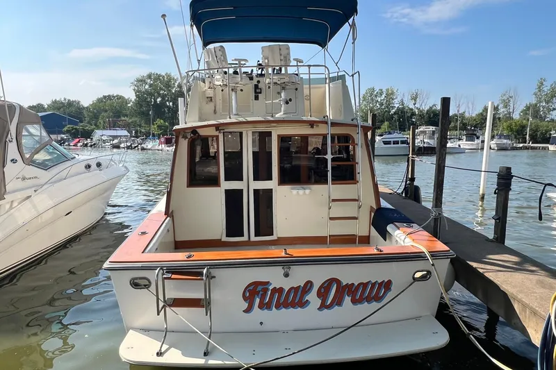 The Image of 1989 Egg Harbor 33 Convertible boat named "Final Draw" docked at a marina. - 1