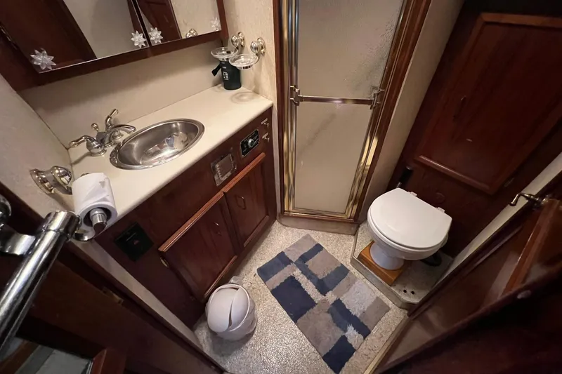 Slide: The Image of Bathroom interior of 1989 Egg Harbor 33 Convertible yacht, featuring sink, toilet, and shower. - 10