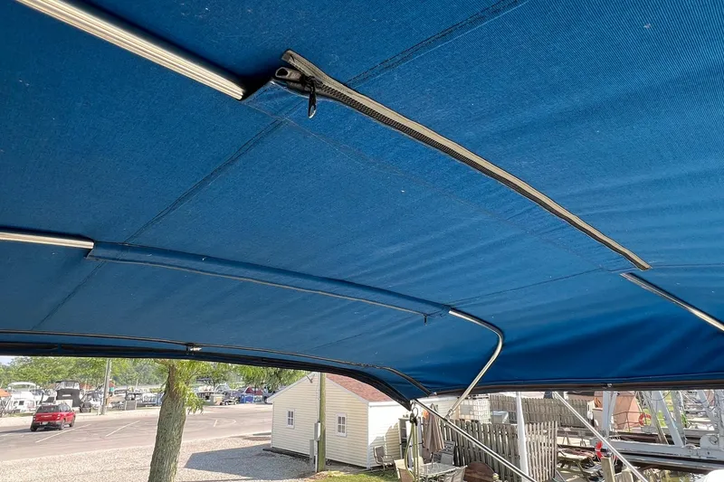 Slide: The Image of 1989 Egg Harbor 33 Convertible boat with blue canvas canopy. - 13